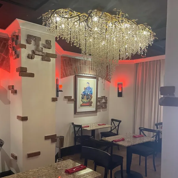 Dining space with crystal chandelier and wall artwork at Shun Lee, a Chinese Restaurant in Lexington