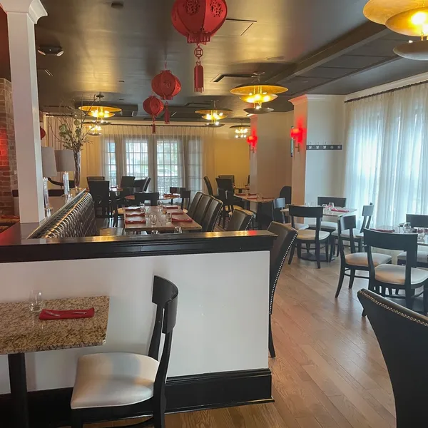 Restaurant interior with red lanterns along dining aisle at Shun Lee, a Chinese Restaurant in Lexington